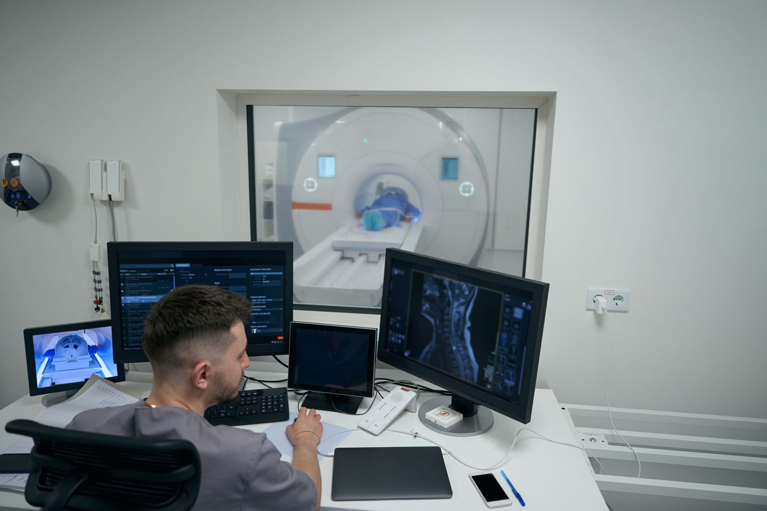 MRI machine, Patient and Imaging Tech during the scan.